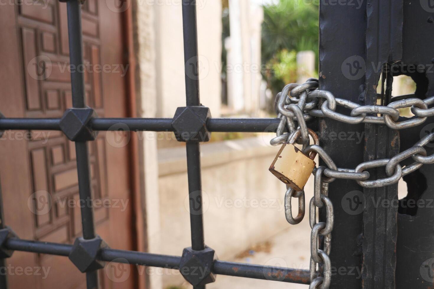 A Secured Gate featuring a Padlock and Chain for enhanced protection and safety measures photo