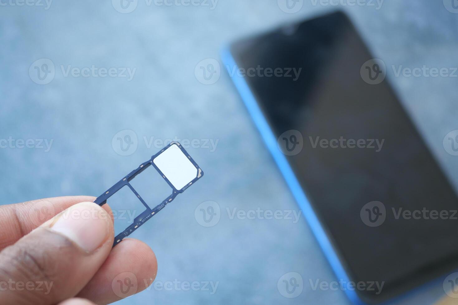 A sim card for a smart phone on finger photo