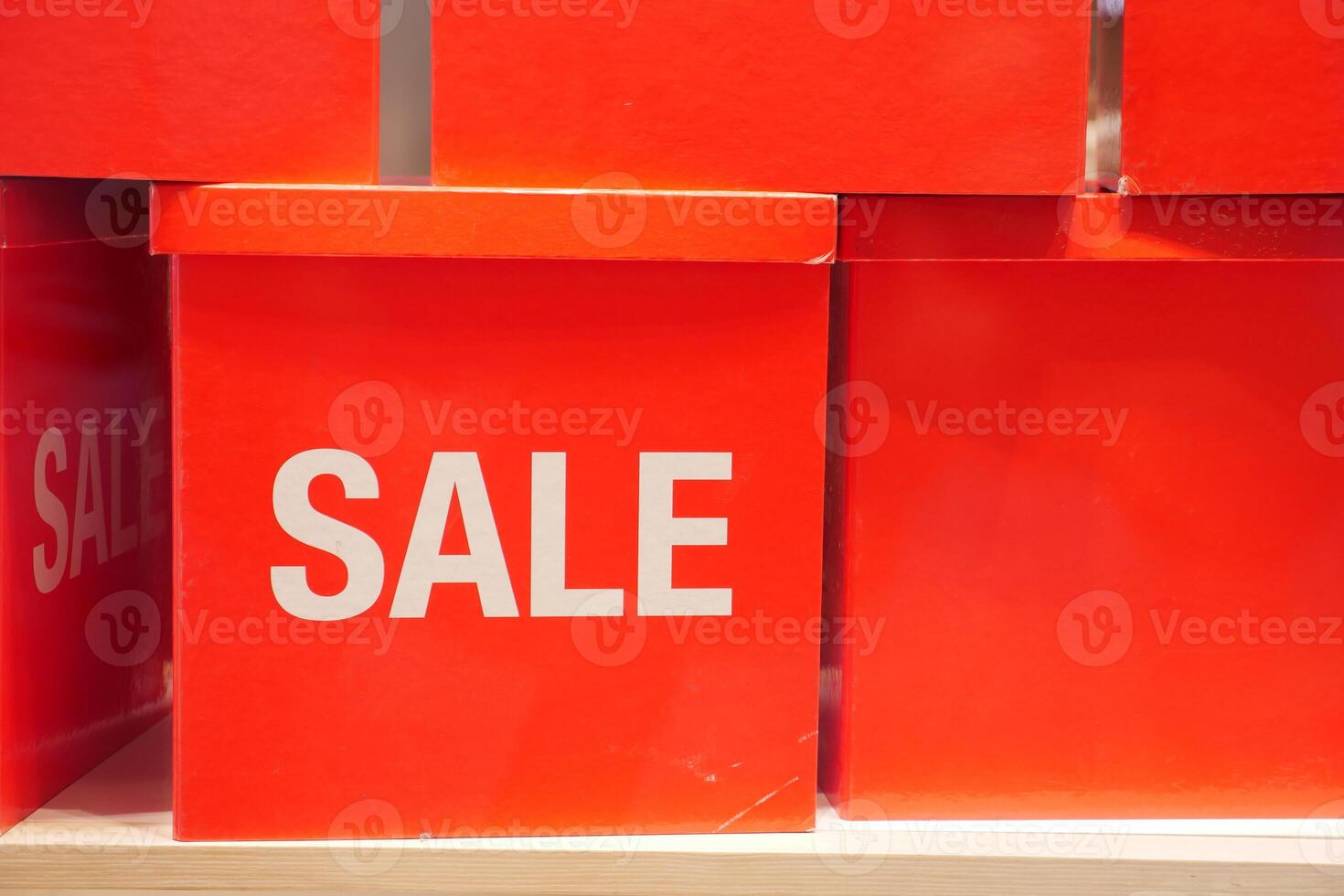 Bright and EyeCatching Red Sale Boxes are Displayed on a Shelf for Maximum Attraction photo