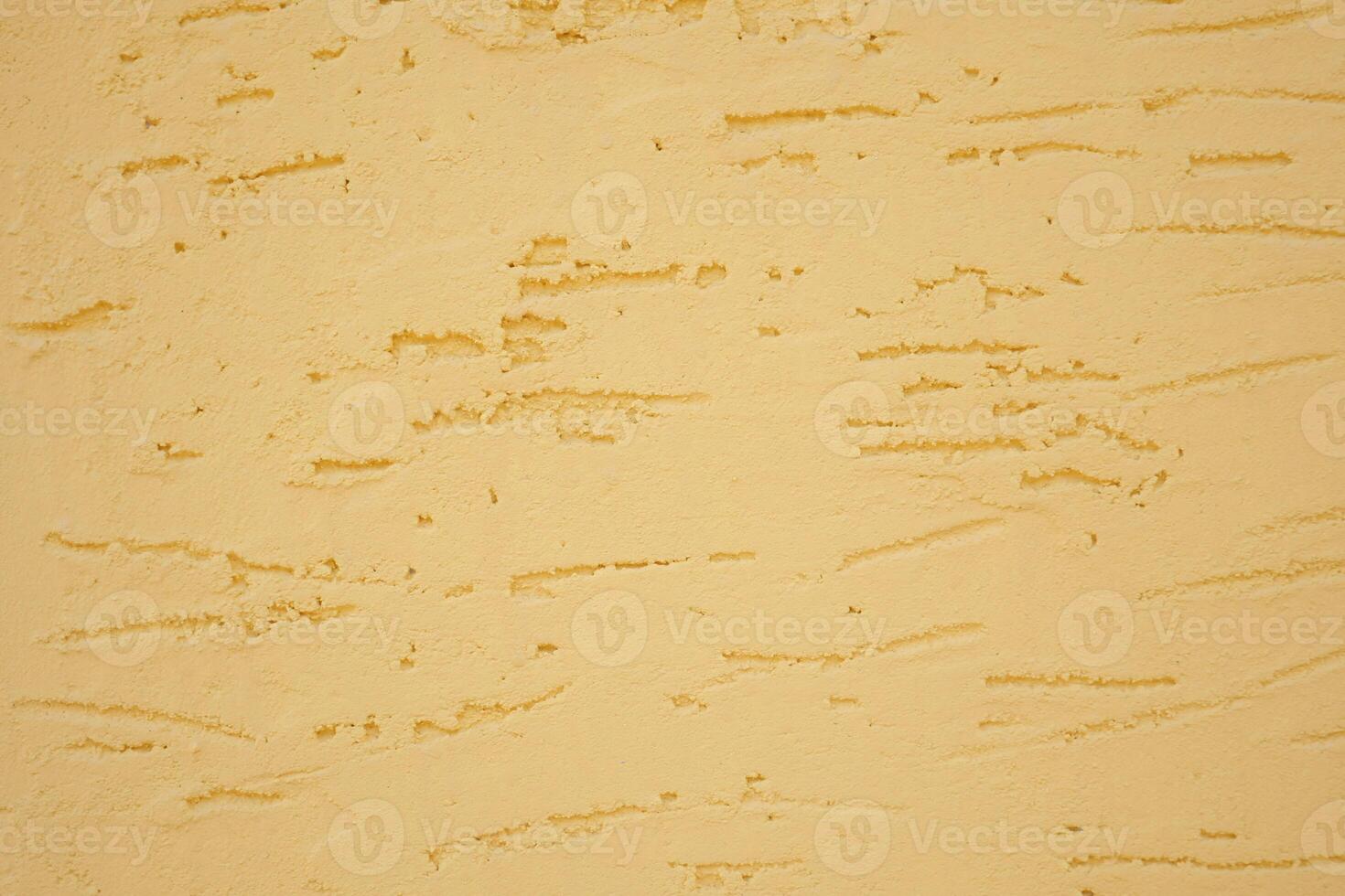 A beautifully textured yellow wall background showcasing subtle striations throughout it photo