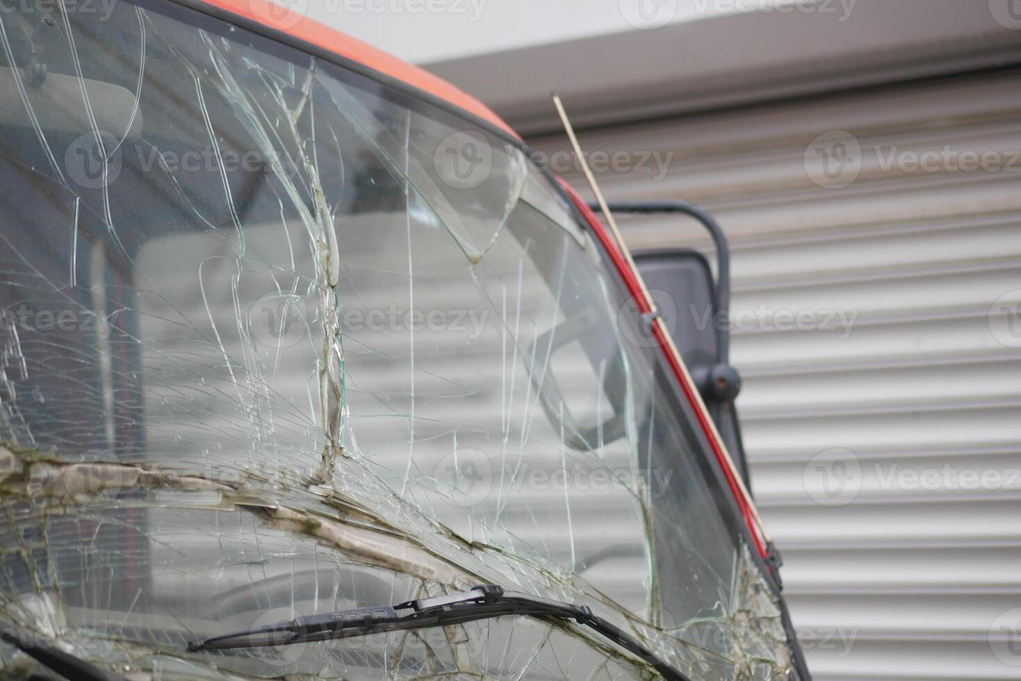 A Damaged Vehicle Windshield with Notable Cracks, Scratches, and Other Imperfections Present photo