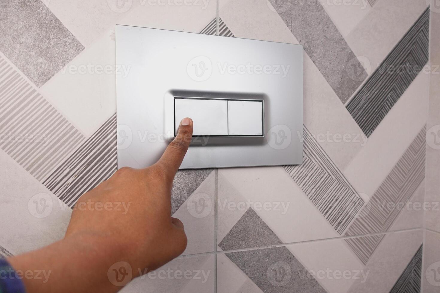 Stylish Modern Bathroom Tile Featuring a Convenient Toilet Flush Button for Easy Operation photo