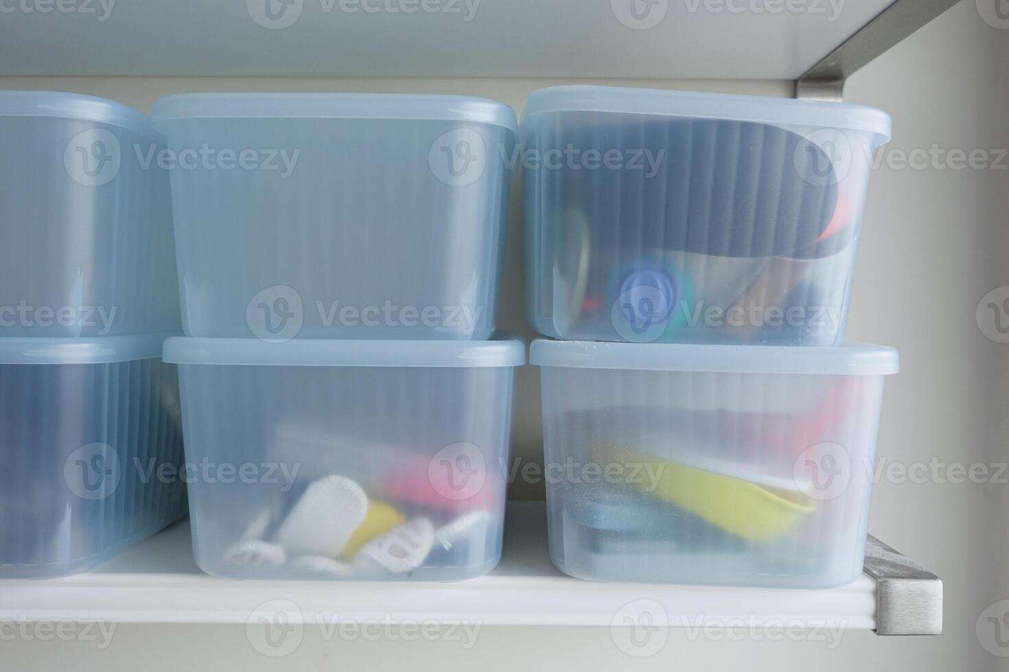 Organized Storage Bins Neatly Arranged on the Shelf for Various Office Supplies and Accessories photo