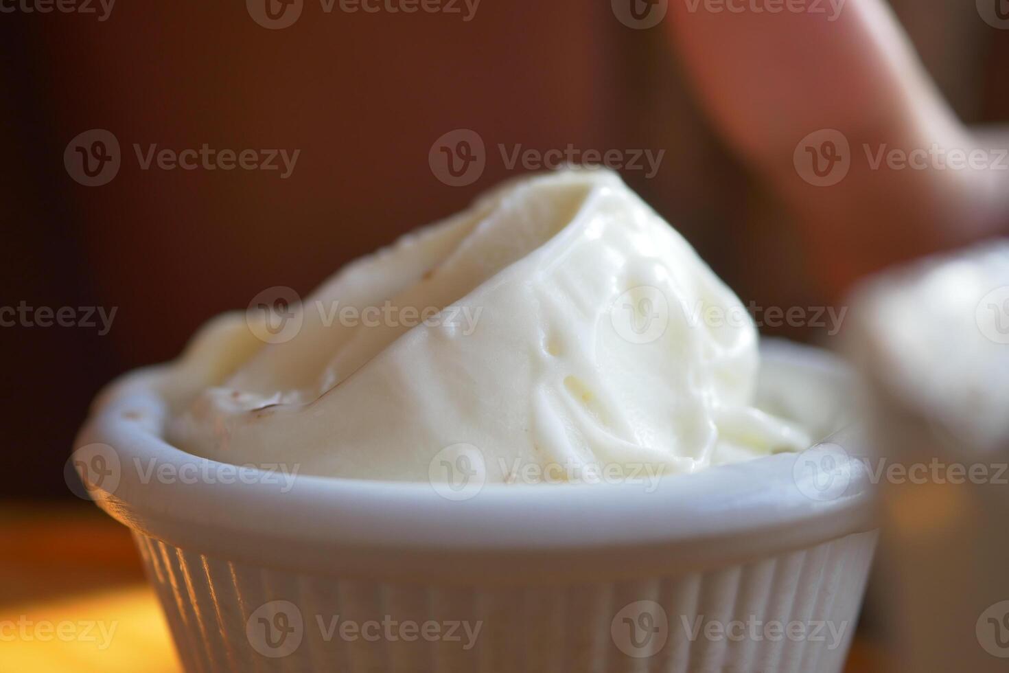 A small dish of creamy butter is elegantly presented with a softly blurred background photo