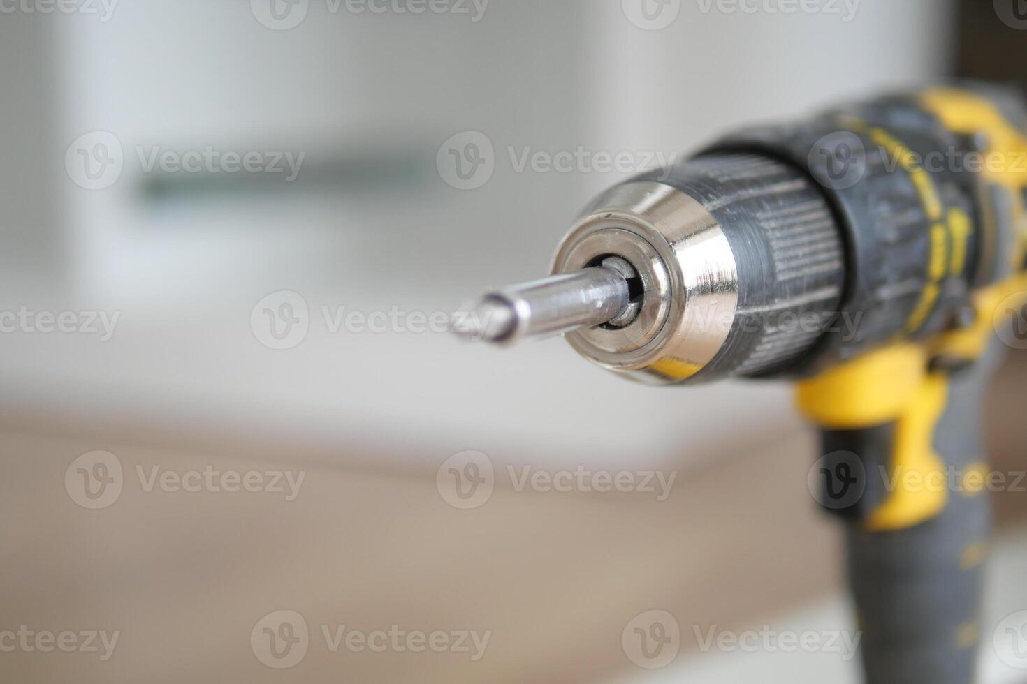 An electric screwdriver is on the floor, photo