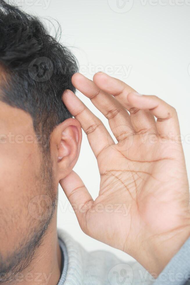 young man having ear pain touching his painful ear , photo