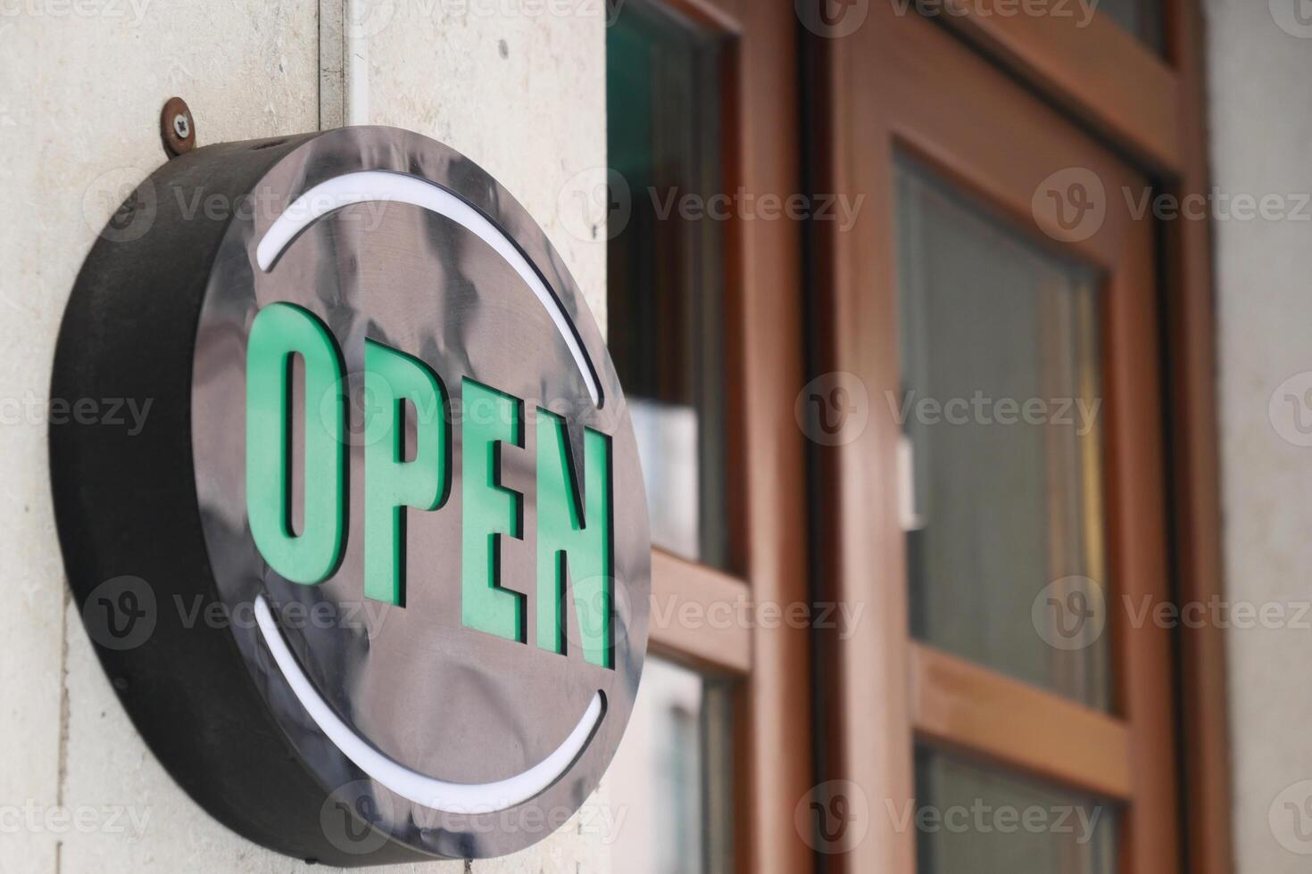 An Illuminated Open Sign is hanging prominently at the entrance of the store, welcoming customers photo