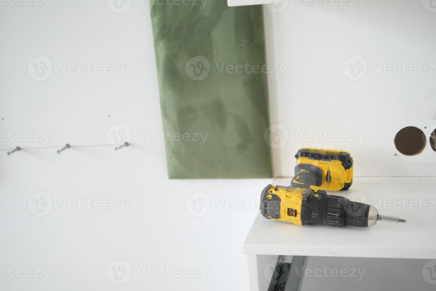 Electric Drill On Shelf During Home Improvement Project photo