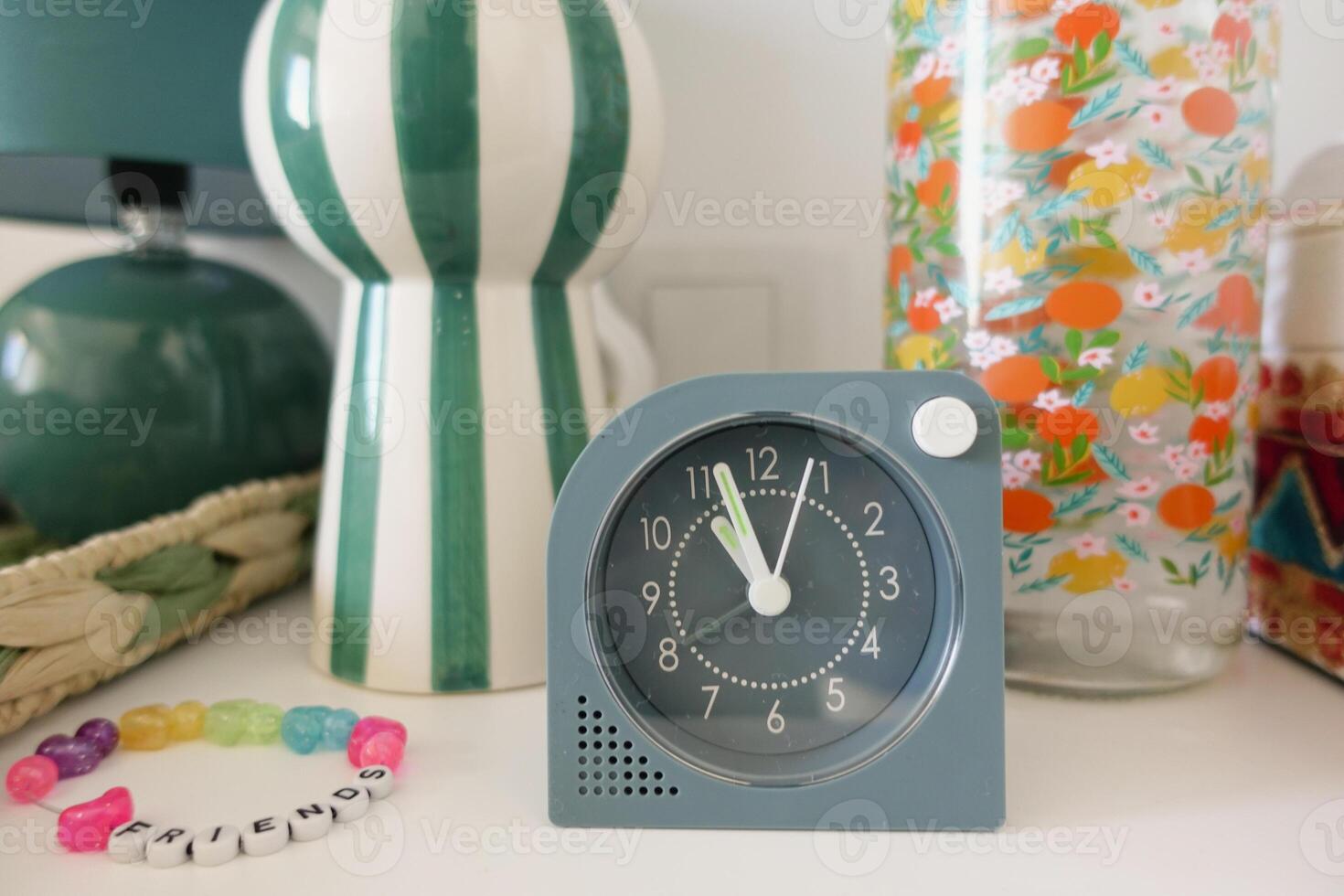 A Vintage Clock Paired with Decorative Accents on a Stylish and Elegant Table Display photo