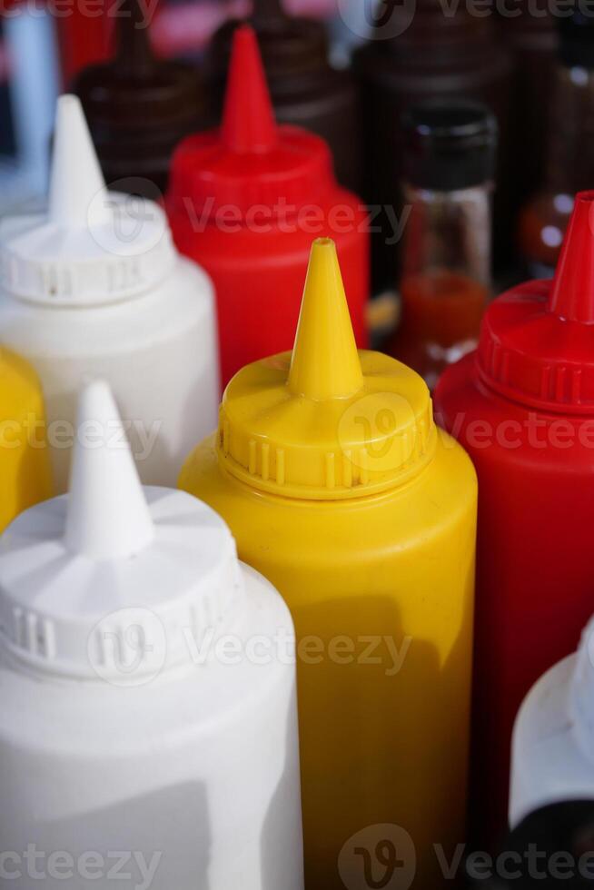 Explore a variety of condiment bottles like ketchup, mustard, and other options photo