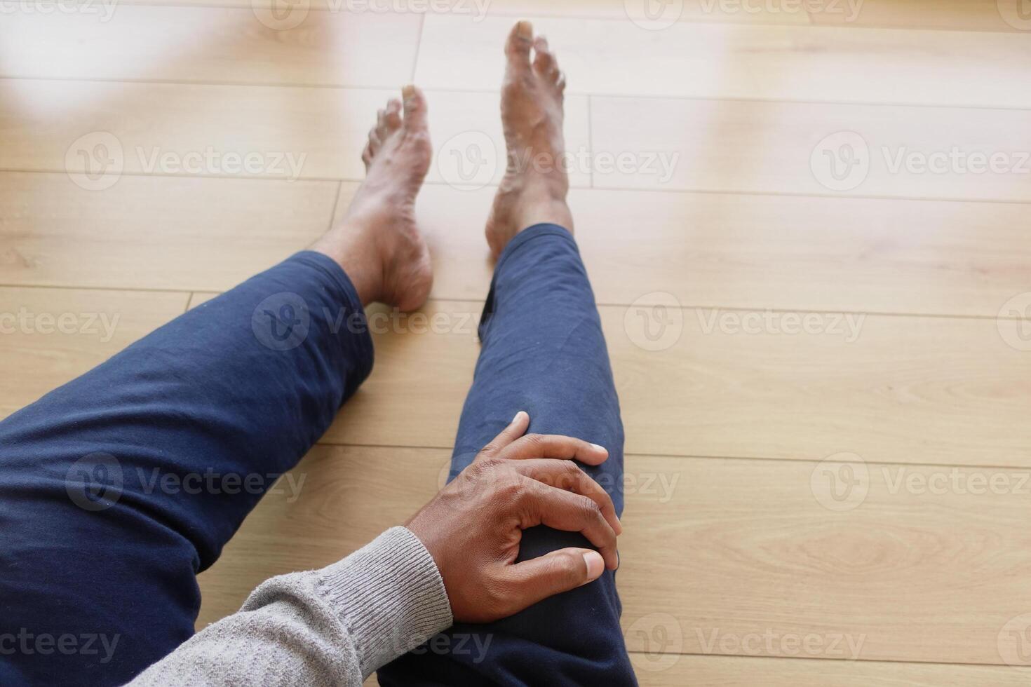 Close up on man suffering knee joint pain photo