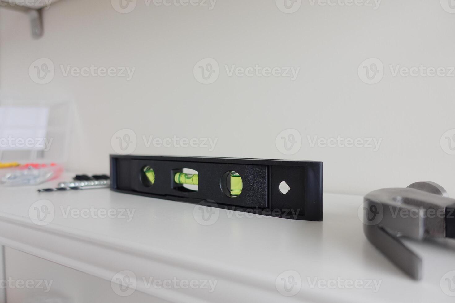 Precision Level Tool Positioned on Shelf Within a Dedicated Workshop Environment Space photo