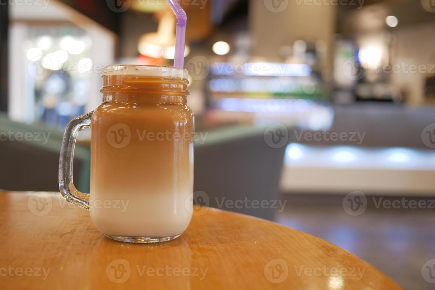 Delicious Layered Coffee Drink in a Cozy Caf Setting photo