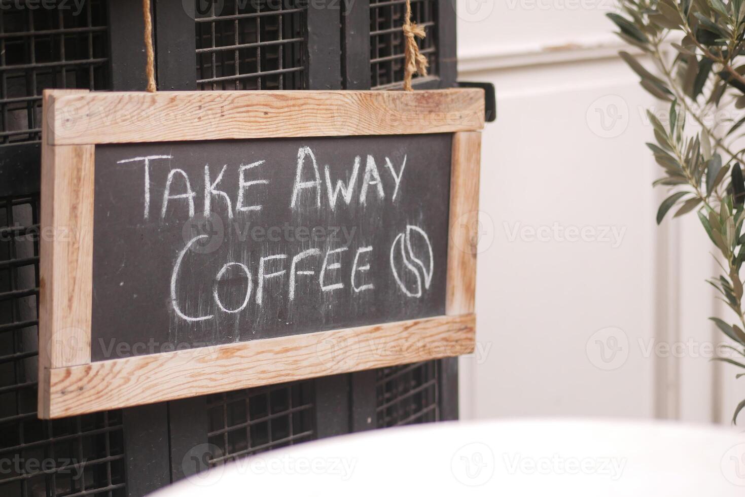 Chalkboard Sign for Takeaway Coffee in Cozy Caf Setting photo
