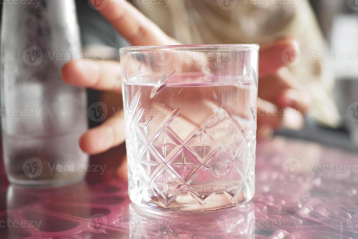 A Refreshing Glass of Clear Water Placed on a Beautifully Colorful and Artistic Table Design photo