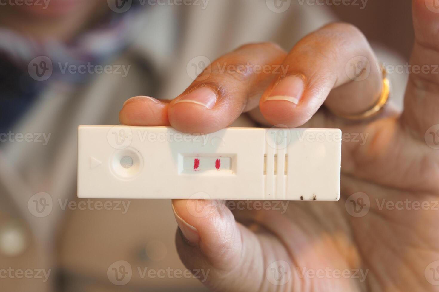 Closeup view of a Positive Medical Test Result held in Hand, showcasing the outcome clearly photo