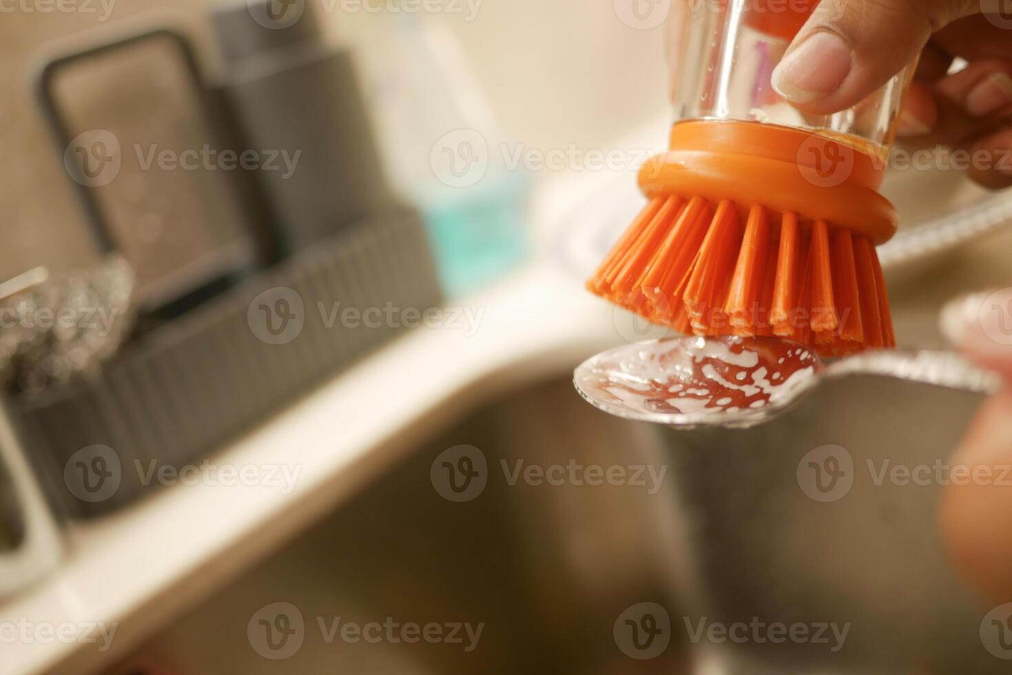 Washing Kitchen Utensils Effectively Using a Brush and Soft Dish Soap for Optimal Clean photo