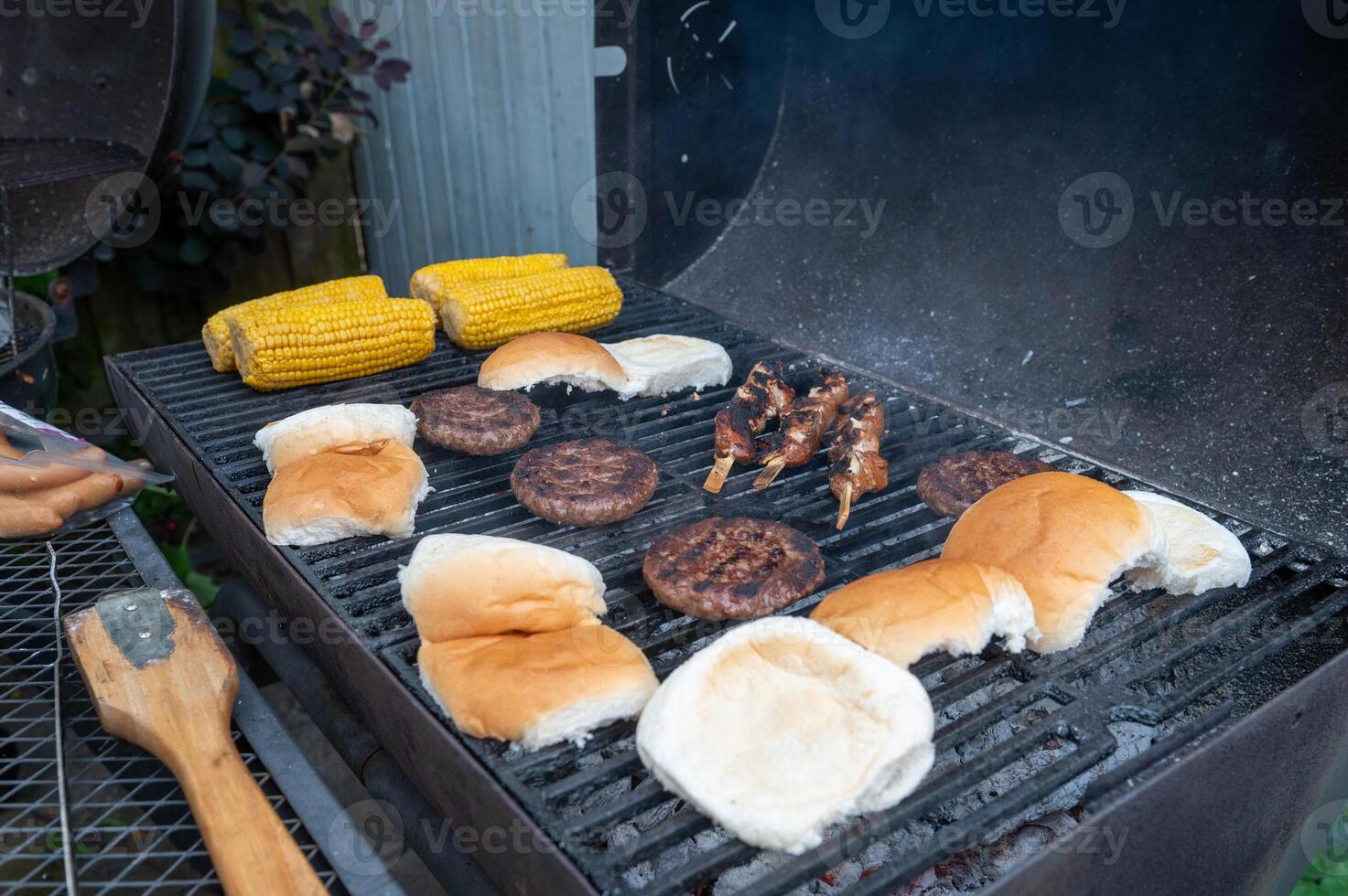 Summertime Backyard Barbecue with Burgers and Corn on the Grill photo