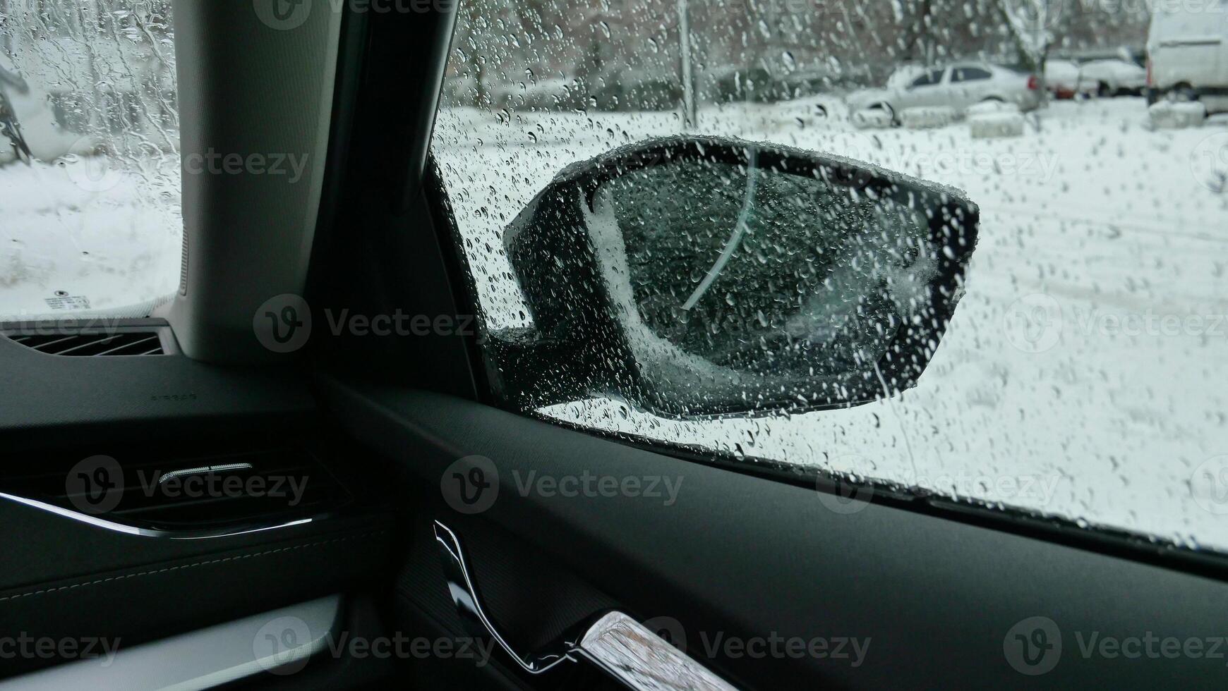 City Yard Parking At Winter Morning. Wet Snow And Cold Drops On The Car Side Window And Mirror photo