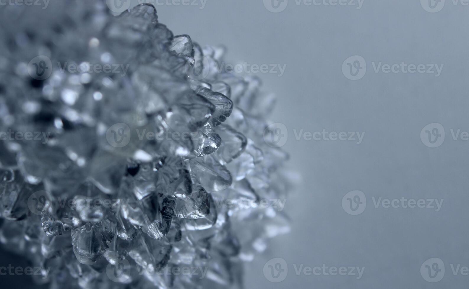 Abstract pattern of ice growths on a light blue background on the side of the image photo