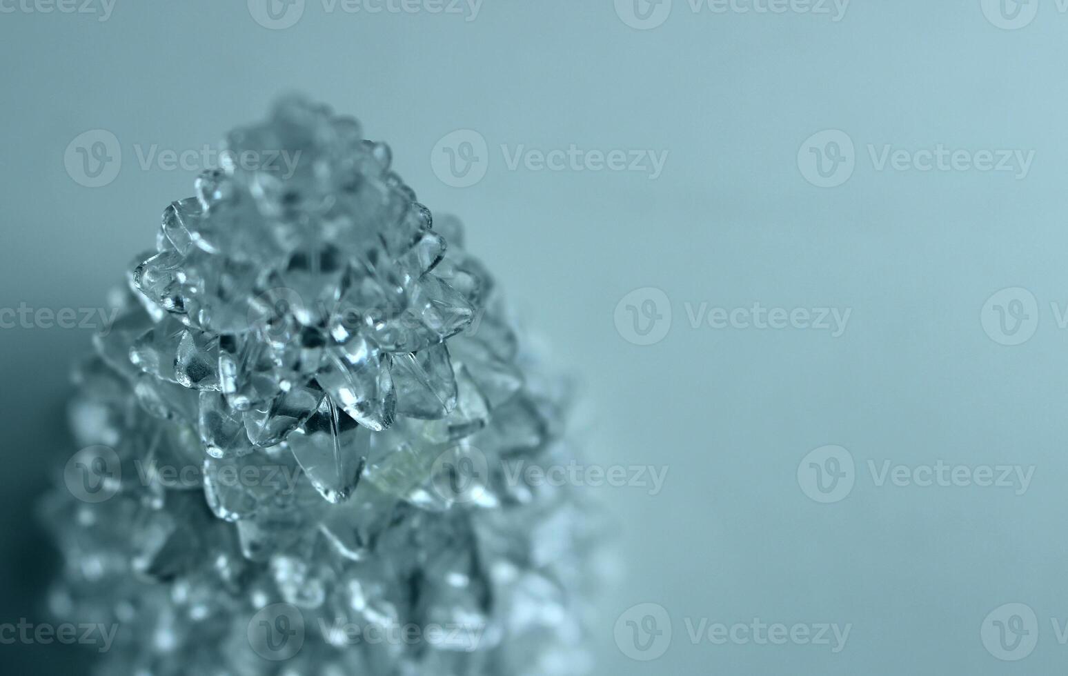 Structure of transparent crystal in the shape of a pyramid with growths tapering at the top photo