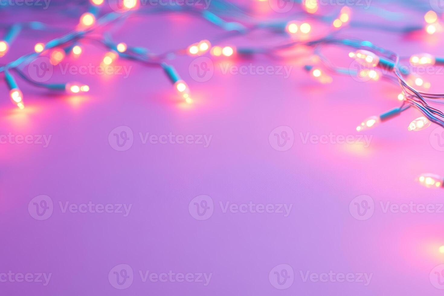 Glowing string lights scattered across a pastel pink background photo