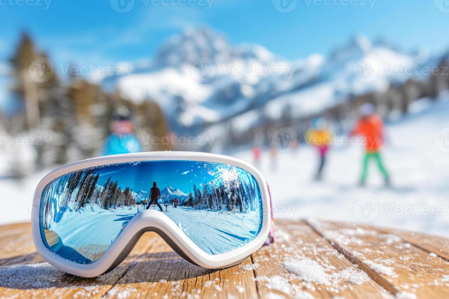 Ski goggles on a wooden table, reflecting a snowy scene with skiers photo