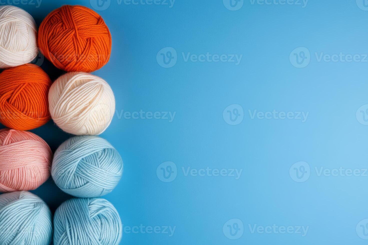 Brightly colored yarn balls on a blue background photo