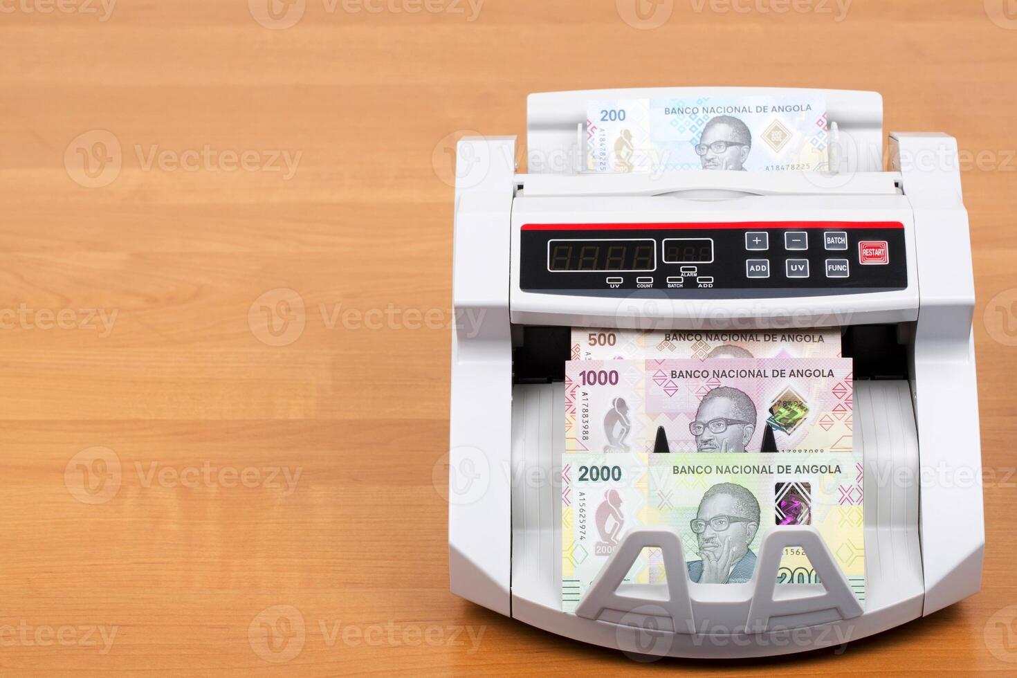 Angolan money in the counting machine photo