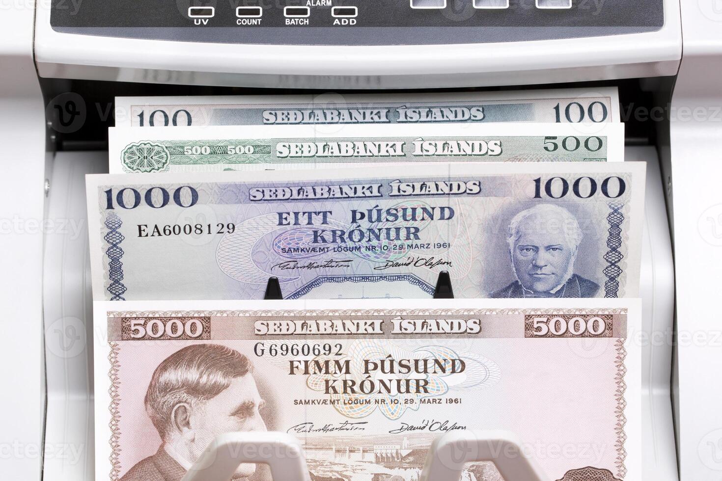 Old Icelandic money in a counting machine photo