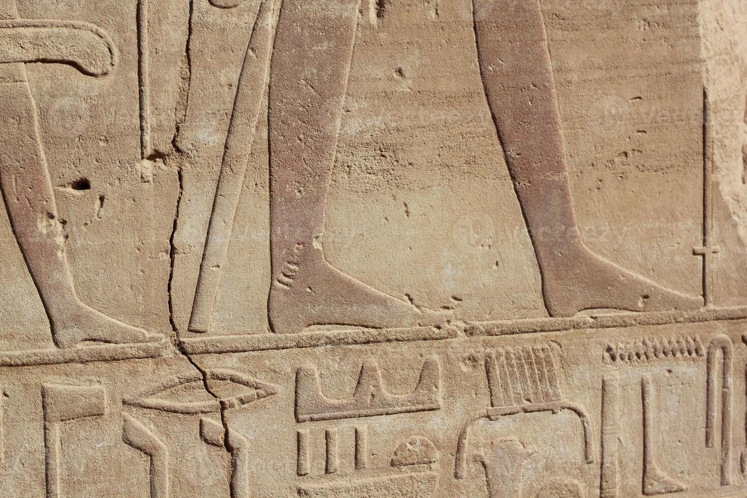 Part of the ancient egyptian scripts and drawings on the wall in Luxor, Egypt. photo