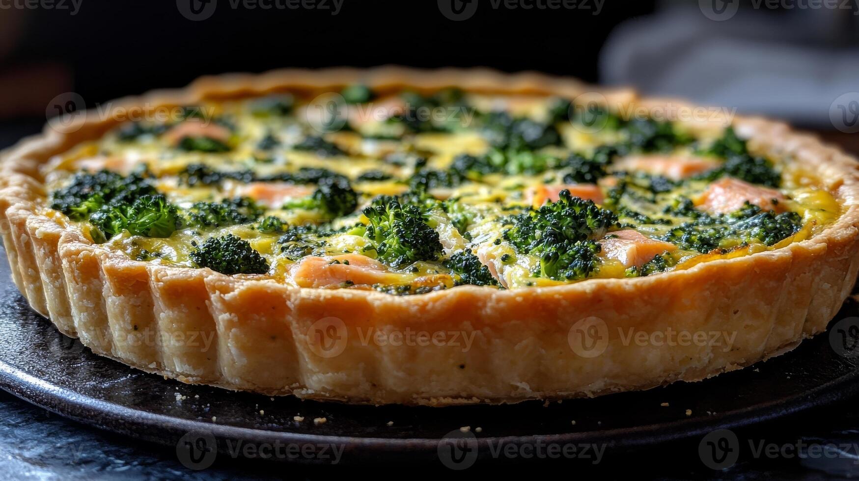 Broccoli and salmon quiche on a dark background, homemade food concept photo
