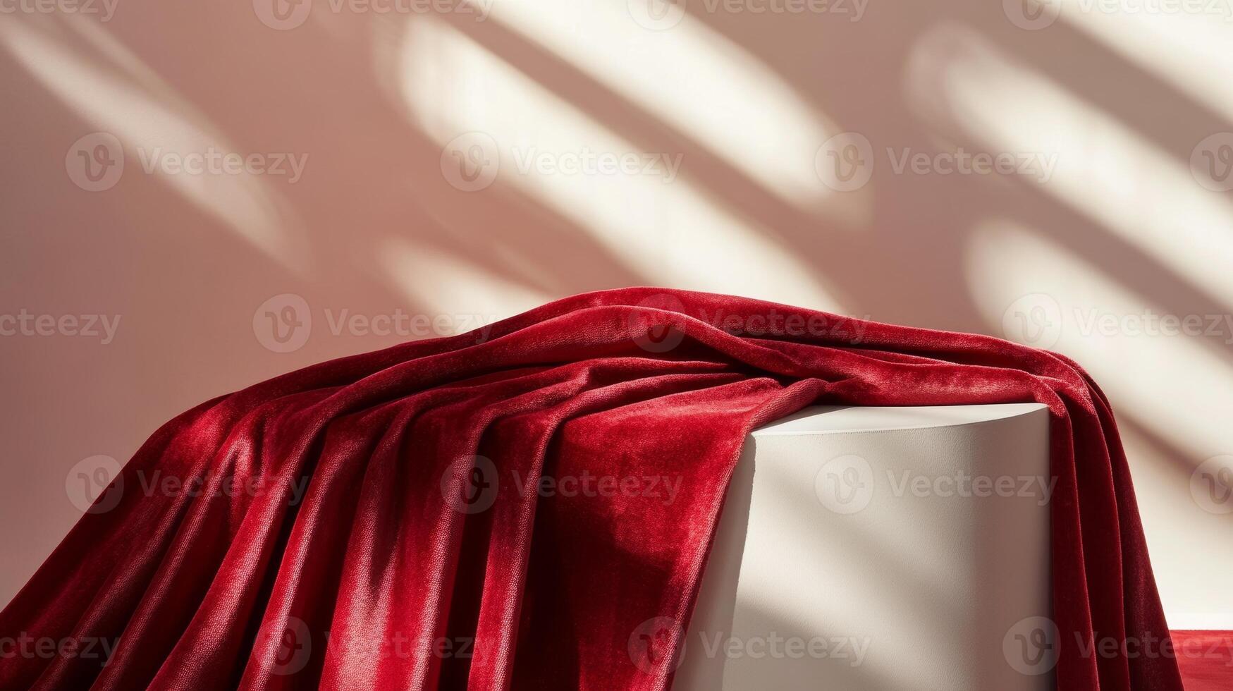 Red velvet fabric draped over a white cube podium with soft light and shadows, minimalist elegance concept photo
