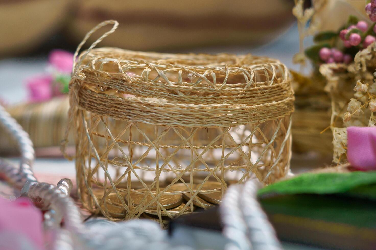 a basket with a string and a pink ribbon photo