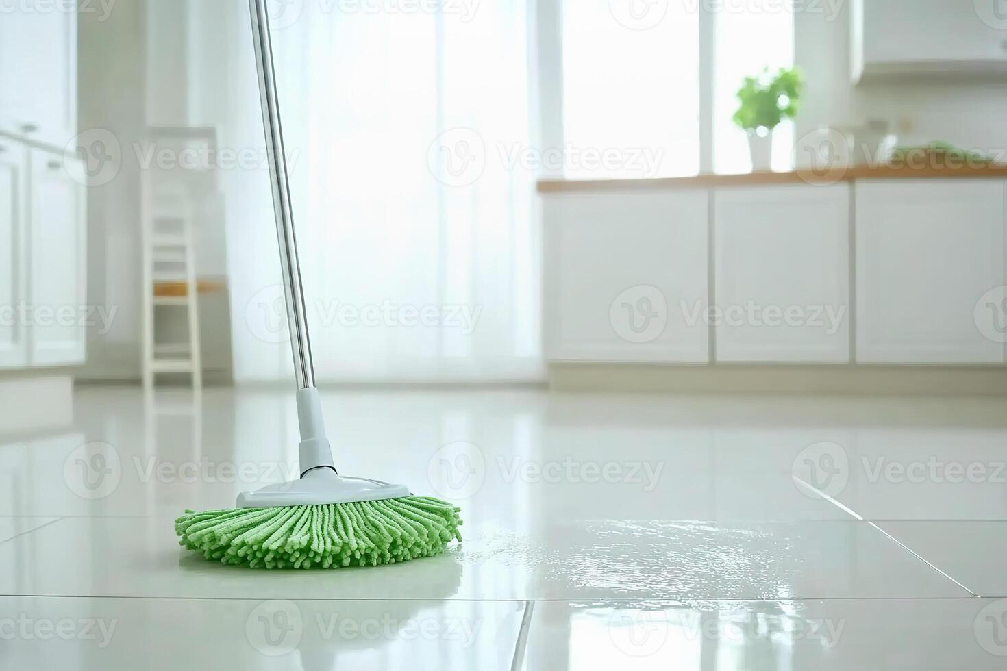Mop cleaning kitchen floor with natural light shining through the windows. photo