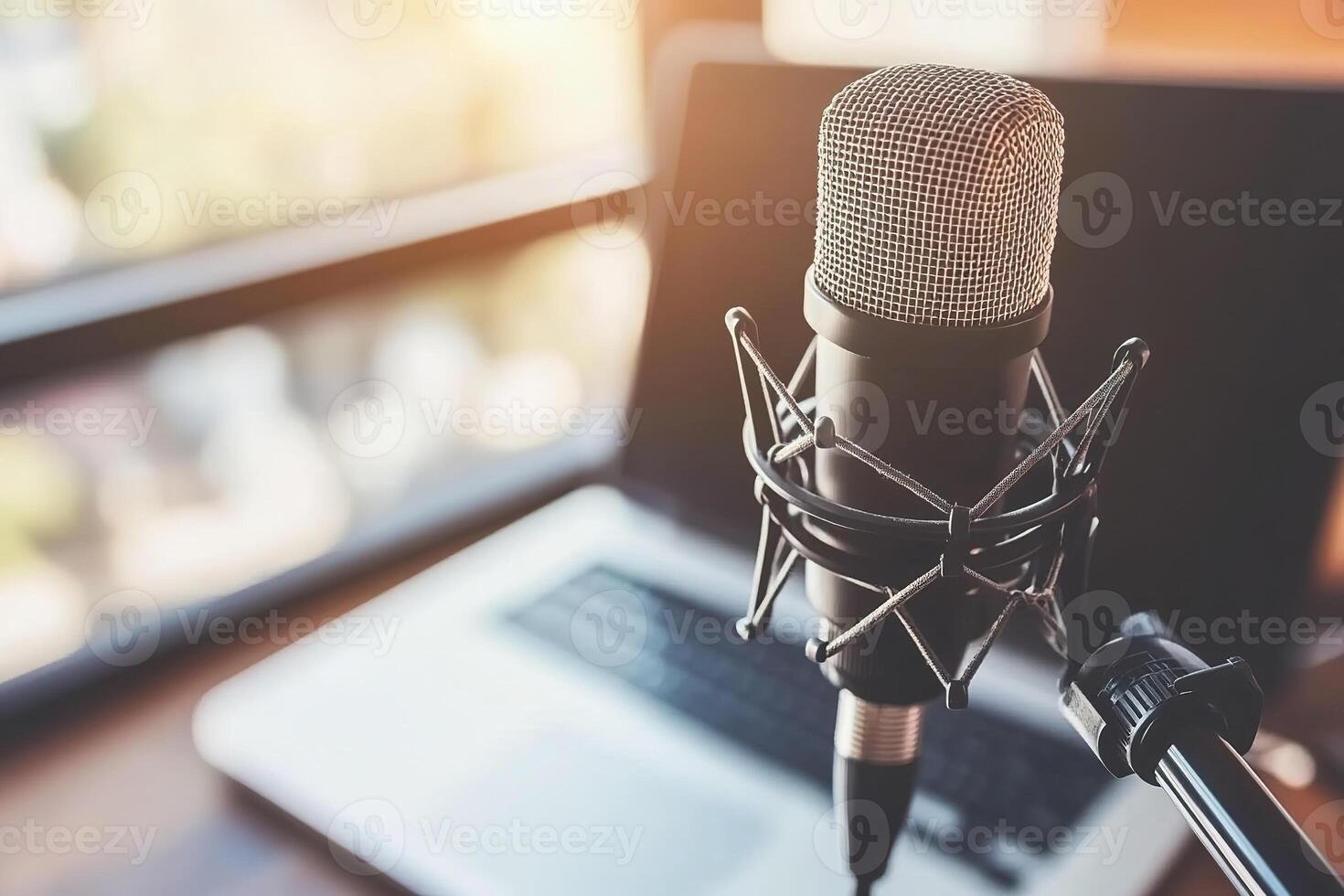 Close up of podcast microphone and laptop in cozy home studio setting. photo