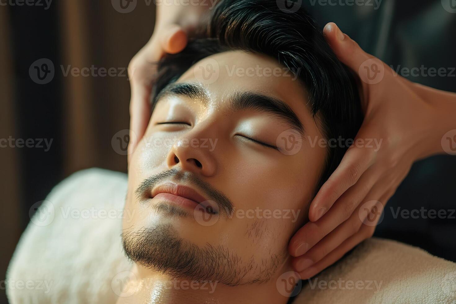 Asian man enjoying relaxing facial treatment at spa. photo