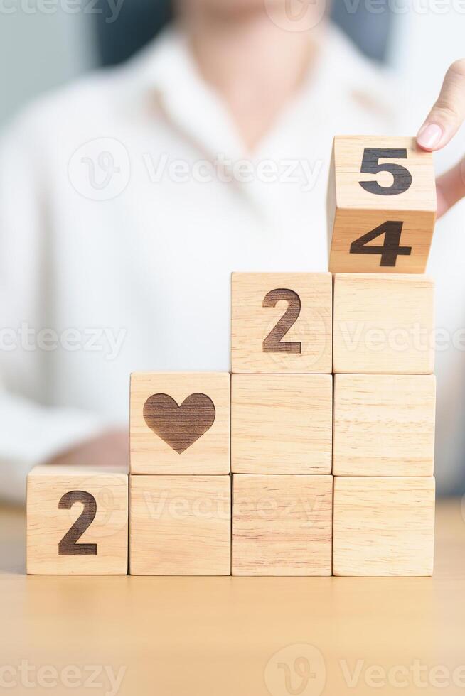 2024 end year to Happy New Year 2025 with heart block for health care, love, organ donation, resolution, charity, happy family, wellbeing and insurance concepts photo