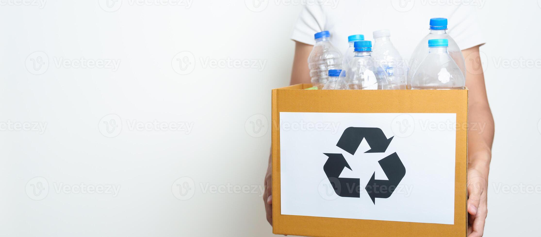 Volunteer keep plastic bottle into paper box at home or office. Hand Sorting Recycle garbage. Ecology, Environmental, pollution, Dispose recycling, waste management and trash Separation concept photo
