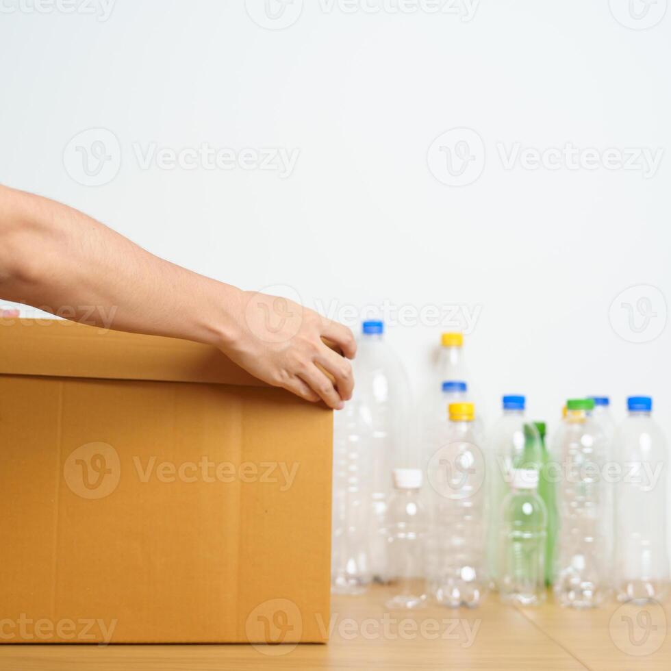 Volunteer keep plastic bottle into paper box at home or office. Hand Sorting Recycle garbage. Ecology, Environmental, pollution, Dispose recycling, waste management and trash Separation concept photo