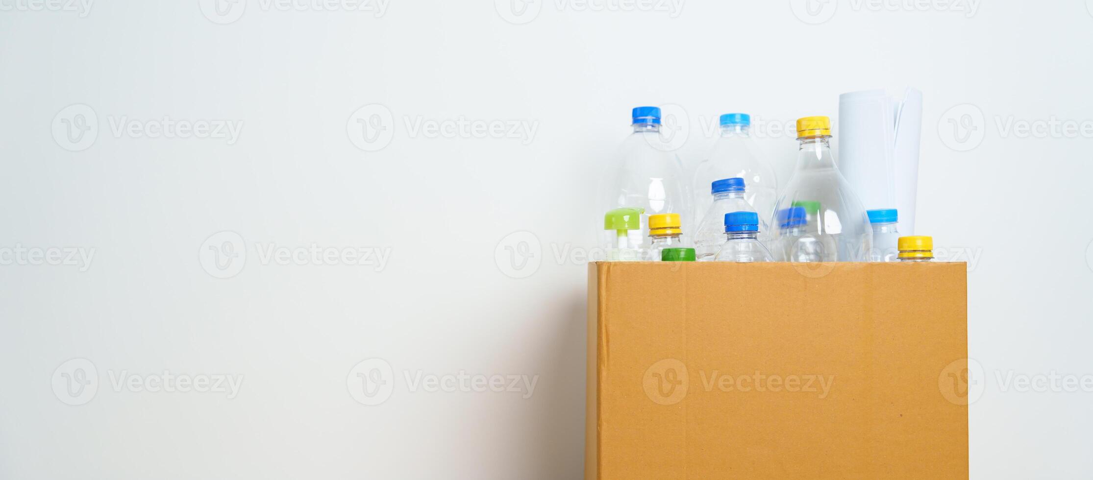 Plastic bottle in paper box at home or office. Recycle garbage Sorting. Plastic Free, Ecology, Environmental, pollution, Dispose recycling, waste management and trash Separation concept photo