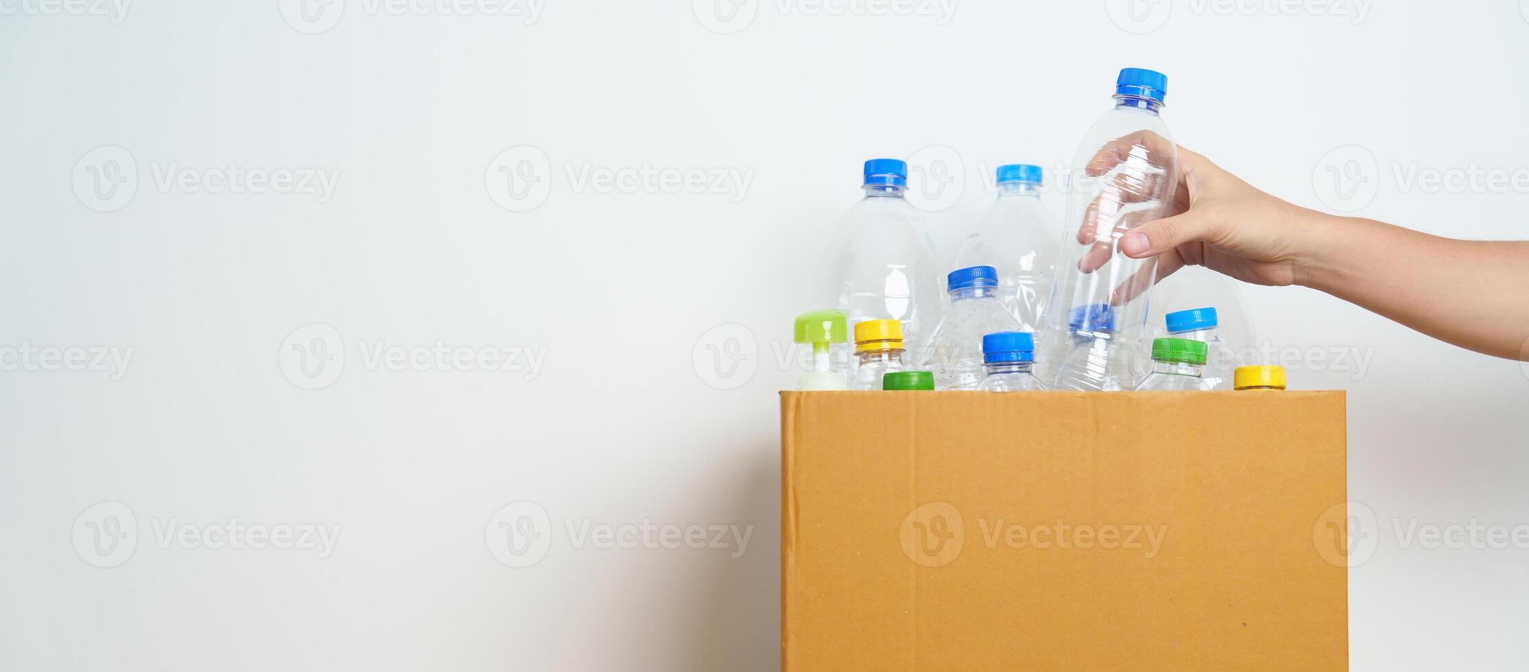 Volunteer keep plastic bottle into paper box at home or office. Hand Sorting Recycle garbage. Ecology, Environmental, pollution, Dispose recycling, waste management and trash Separation concept photo