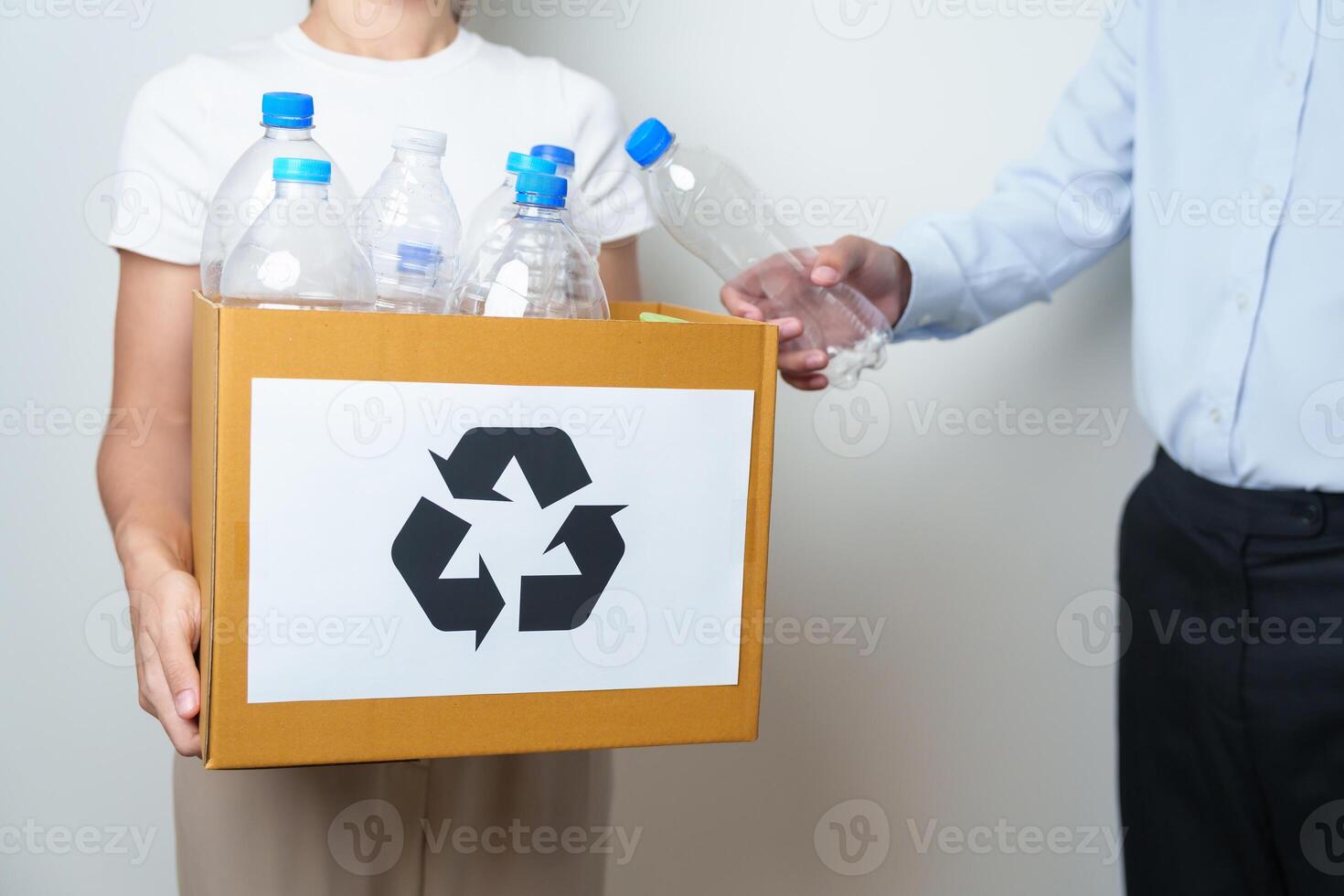 Volunteer keep plastic bottle into paper box at home or office. Hand Sorting Recycle garbage. Ecology, Environmental, pollution, Dispose recycling, waste management and trash Separation concept photo