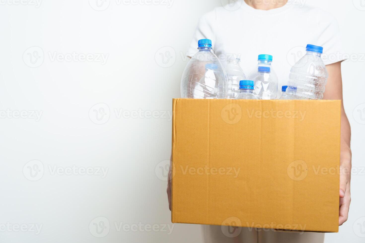 Volunteer keep plastic bottle into paper box at home or office. Hand Sorting Recycle garbage. Ecology, Environmental, pollution, Dispose recycling, waste management and trash Separation concept photo