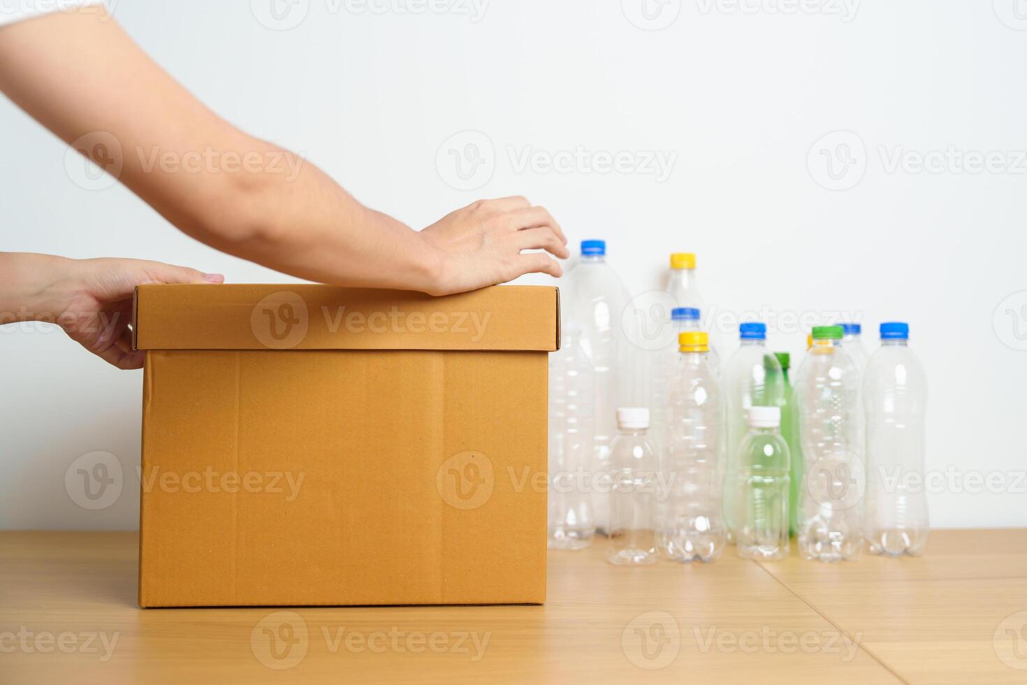 Volunteer keep plastic bottle into paper box at home or office. Hand Sorting Recycle garbage. Ecology, Environmental, pollution, Dispose recycling, waste management and trash Separation concept photo