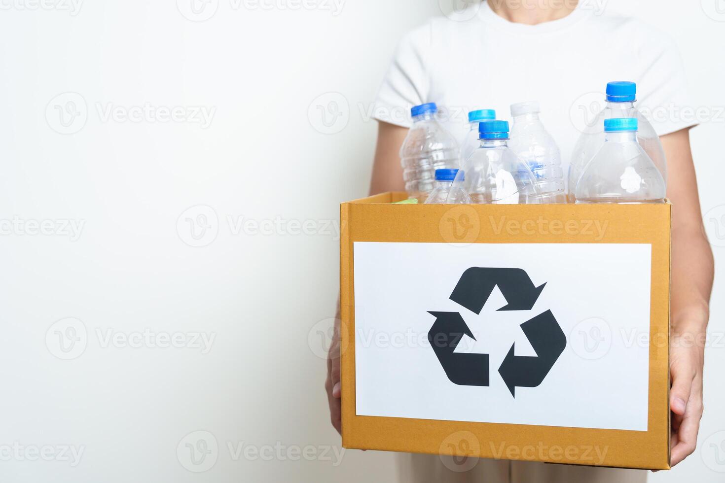 Volunteer keep plastic bottle into paper box at home or office. Hand Sorting Recycle garbage. Ecology, Environmental, pollution, Dispose recycling, waste management and trash Separation concept photo