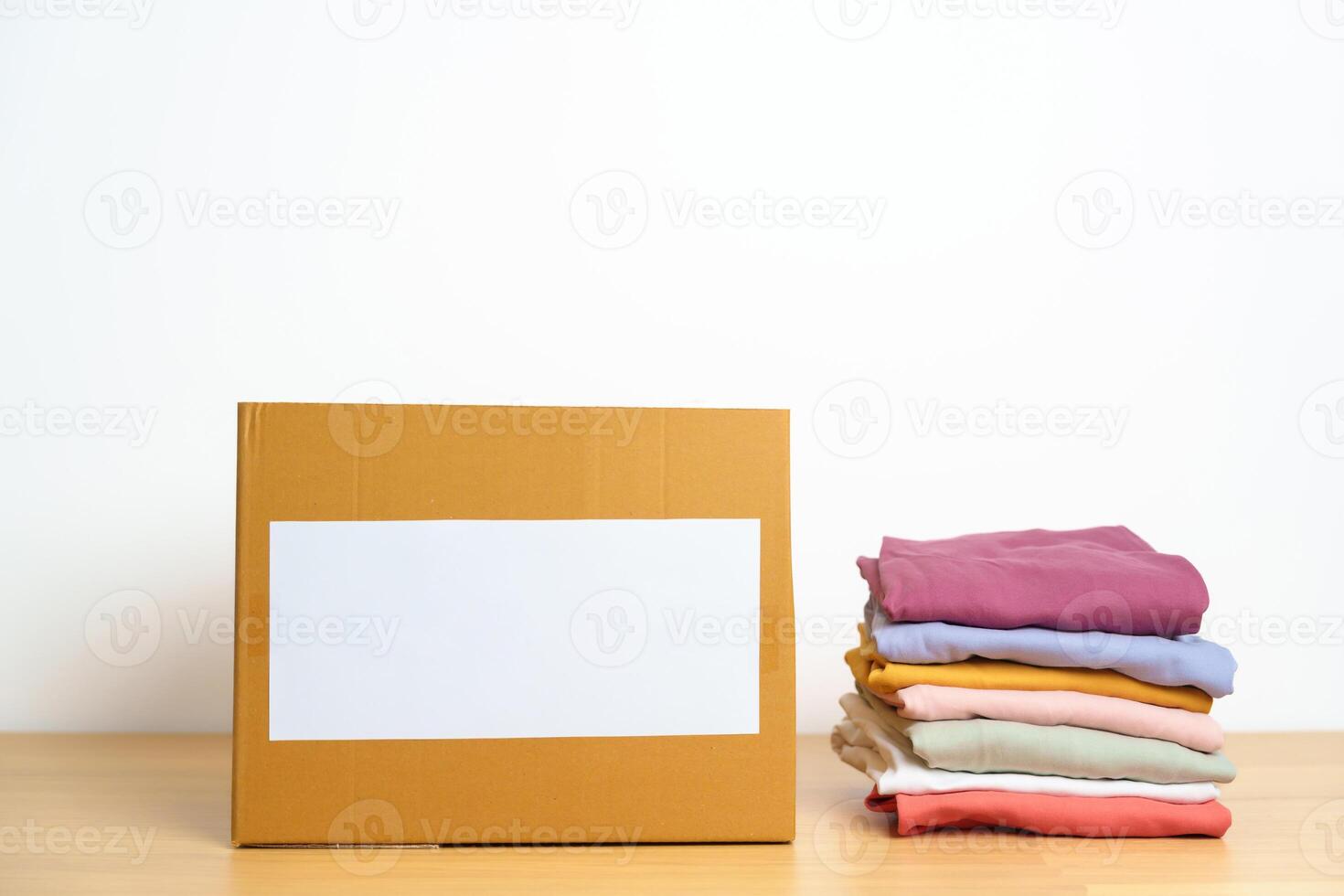 Donation, Charity, Volunteer, Giving, Delivery and Home Moving Concept. Clothes with cardboard box at home or offices for support and help poor, refugee and homeless people. Copy space for text photo