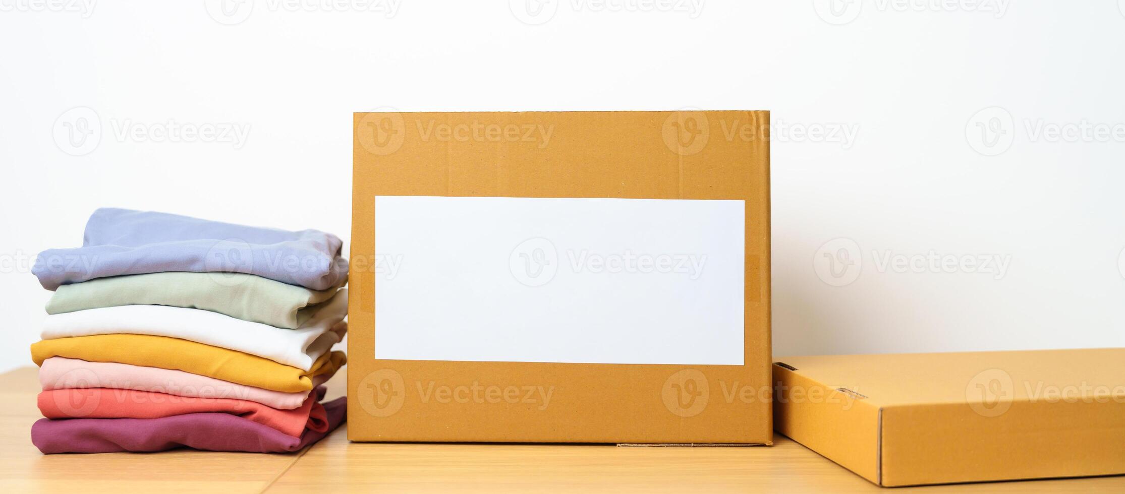 Donation, Charity, Volunteer, Giving, Delivery and Home Moving Concept. Clothes with cardboard box at home or offices for support and help poor, refugee and homeless people. Copy space for text photo