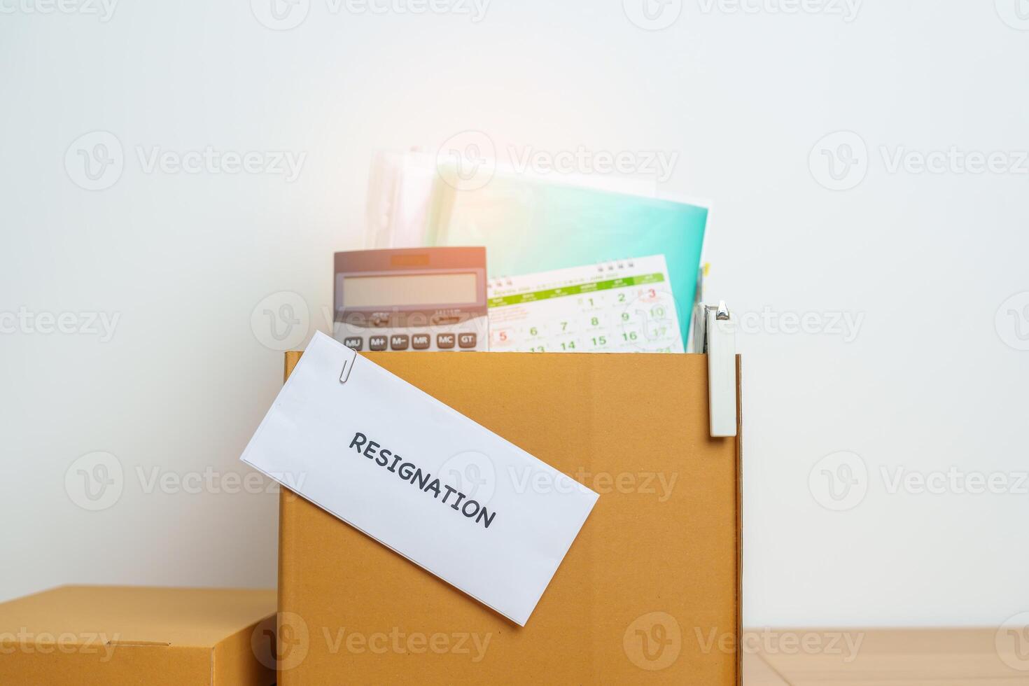 Resignation, Layoff, Unemployment, Dismiss, Job quit, Jobless and Farewell concept. letter of Resign contract with documents cardboard box at office photo