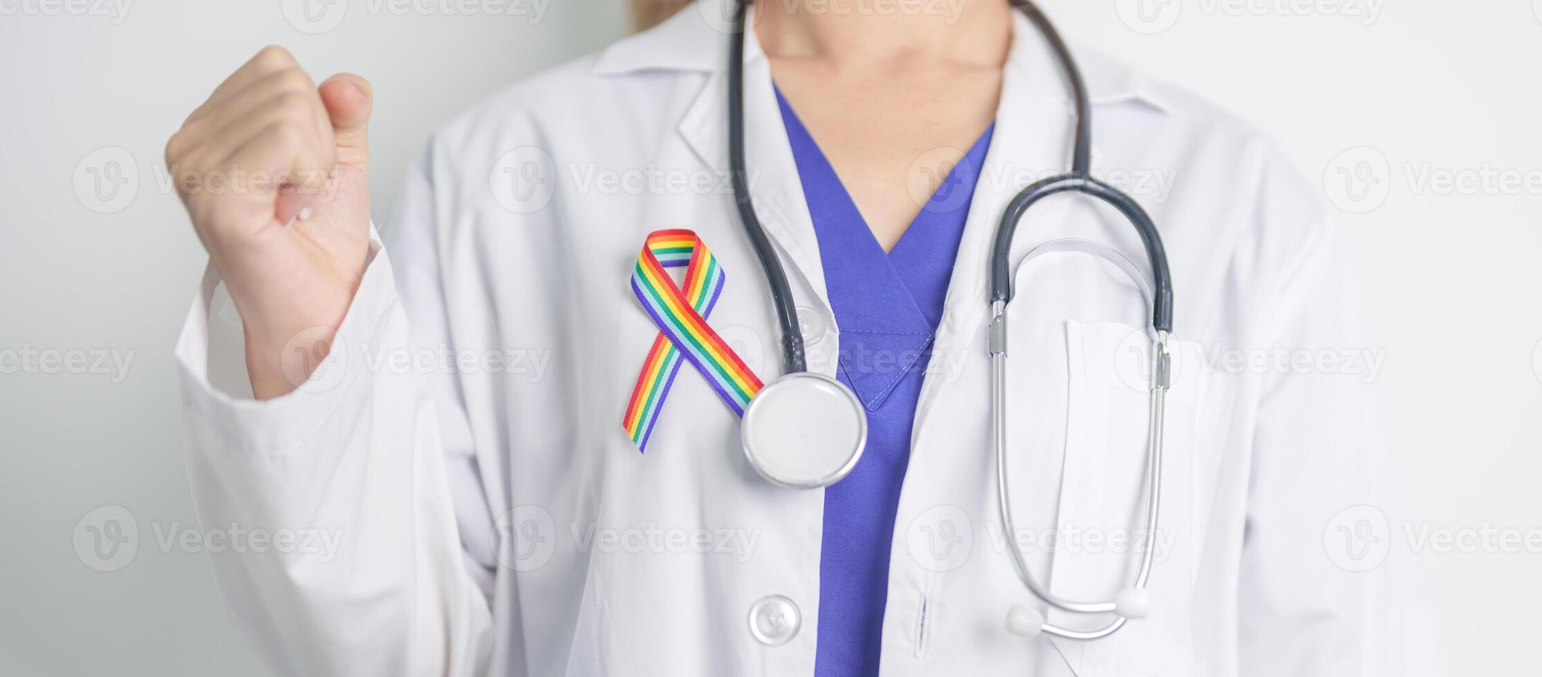 Doctor with LGBTQ Rainbow ribbon for Support Lesbian, Gay, Bisexual, Transgender and Queer community and happy Pride month concept photo